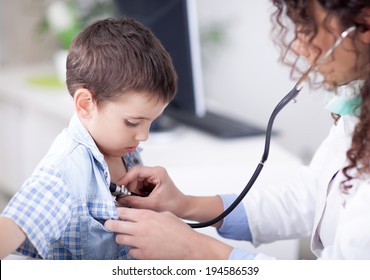  friendly female doctor examining a little boy