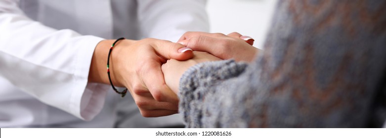 Friendly female doctor hold patient hand in office during reception. Examination result positive test calm down promise and cheer up grief and suffer treatment condolence ethics concept - Powered by Shutterstock