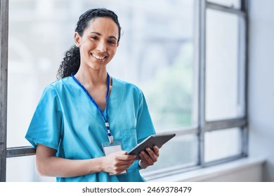 Friendly Female Doctor Smiling and Using Tablet in Modern Hospital Setting - Powered by Shutterstock