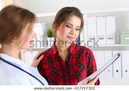 Friendly female doctor touching patient shoulder for encouragement, empathy, cheering and support after medical examination. Trust and ethics concept. Good news, healthcare and medical service concept