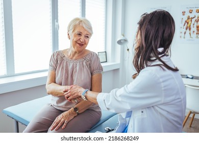 Friendly Female Doctor's Hands Holding Female Patient's Hand For Encouragement And Empathy. Partnership Trust And Medical Ethics Concept. Doctor Giving Hope. 