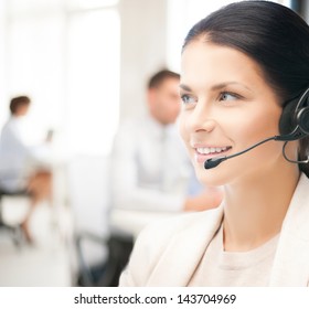 friendly female helpline operator with headphones in call center - Shutterstock ID 143704969