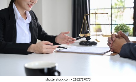 Friendly Female Lawyer In Suit Consulting With Client. Lawyer, Justice And Law And Attorney Concept