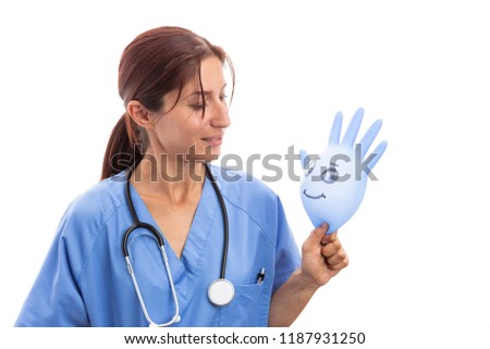 Friendly female pediatrician nurse looking at smiling latex glove isolated on white background