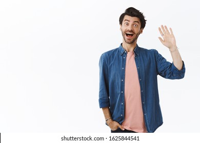 Friendly, Good-looking Bearded Guy Saying Hi And Waving Raised Arm In Greeting, Surprised Man See Familiar Person On Street, Very Happy, Introduce Himself Or Saying Farewell, White Background