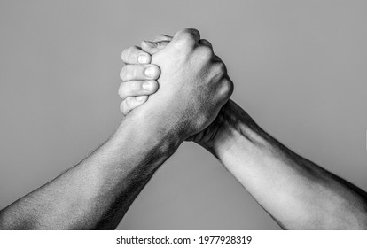 Friendly handshake, friends greeting, teamwork, friendship. Handshake, arms, friendship. Hand rivalry vs challenge strength comparison Black and white