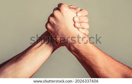 Friendly handshake, friends greeting, teamwork, friendship. Handshake, arms, friendship Hand rivalry vs challenge strength comparison