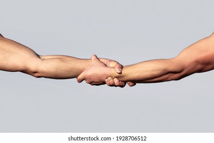 A Friendly Handshake. Two Hands, Shaking Hands. Two Hands, Helping Arm Of A Friend, Teamwork. Rescue, Helping Gesture Or Hands. Close Up Help Hand. Helping Hand Concept, Support.