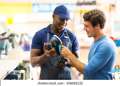 Friendly Hardware Store Worker Showing Customer A Sander