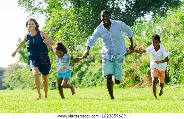 friendly-interracial-family-two-children-600w-1623859669.jpg