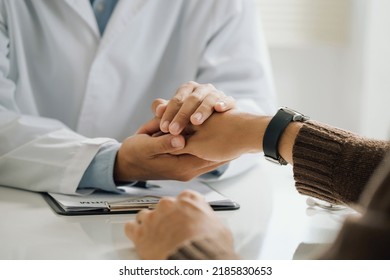 Friendly Male Doctor Holding Patient's Hand For Encouragement And Empathy. Partnership, Trust, And Medical Ethics Concept. Support Patient Cheering And Support.encouragement To Get Through The Crisis