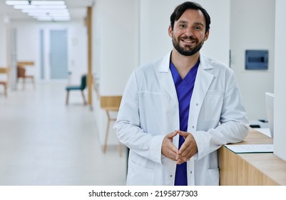 Friendly Male General Practitioner Wearing Medical Uniform Standing In Modern Medical Clinic, Portrait. Doctor Occupation