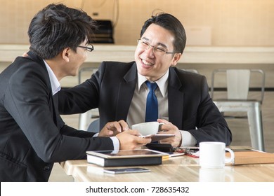 Friendly Middle Aged Boss / Manager Talking With Staff / Employee During Meeting In The Office.