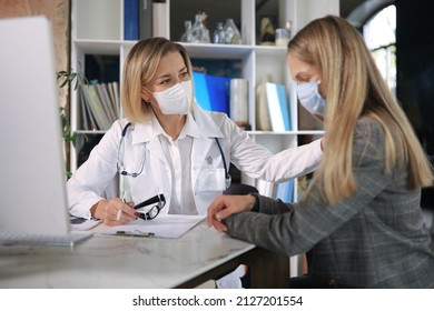 Friendly Middle Aged Female Doctor Encouraging, Supporting Patient After Medical Examination