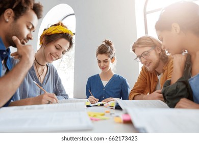 Friendly Multiracial Young Researcher Meeting Together To Discuss Main Themes. Young Writers Gaving Meeting Presenting Their Books. Group Of Students Being Glad To Work Together Planning Presentation