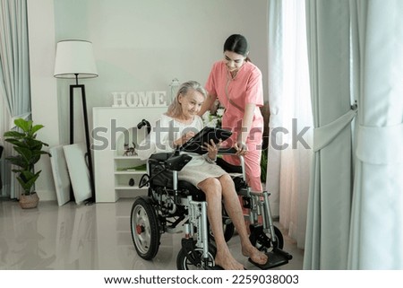 Similar – Caregiver with elderly patient in a wheelchair in front of window