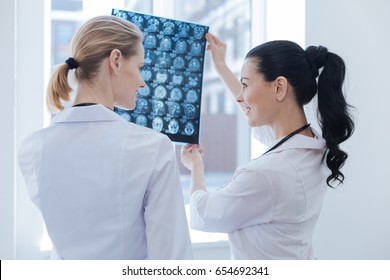 Friendly Nurses Discussing Ct Scan Results At The Roentgen Cabinet