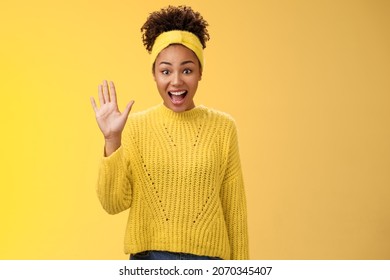 Friendly outgoing excited cute millennial female coworker newbie greeting team waving palm hi hello gesture energized get know new people welcoming greeting friends, standing yellow background