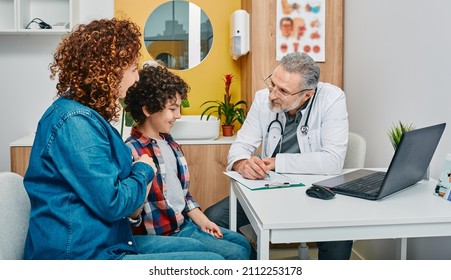 Friendly pediatrician communicate with her child patient at doctor's office while pediatrician consultation. Kid health - Powered by Shutterstock