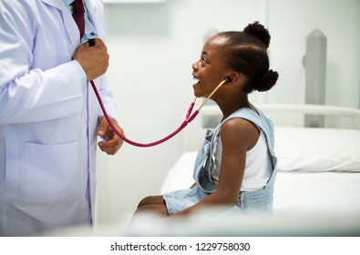 Friendly pediatrician entertaining his patient