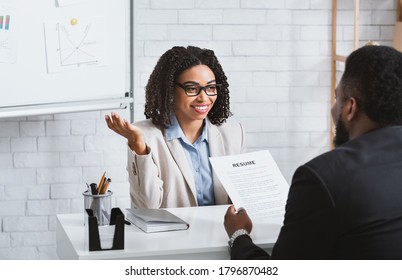 Friendly personnel manager interviewing black candidate during job interview at modern office, panorama