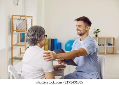 Friendly Physician At Modern Clinic Or Hospital Communicating With Senior Woman. Happy Elderly Lady Gets Advice And Support From Practitioner. Medicine, Help, Care, Doctor Patient Interaction