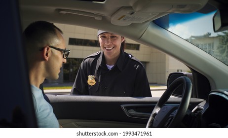 Friendly Police Officer Checking Driver License Of Man