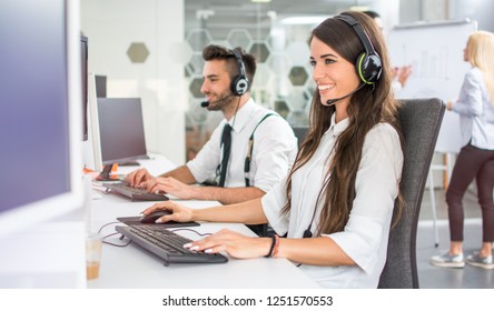 Friendly positive female business consultant, call center operator in call centre office - Powered by Shutterstock