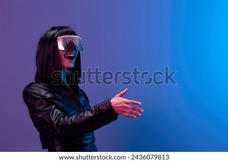 Friendly pretty awesome brunet woman in leather jacket trendy specular sunglasses greet someone posing isolated in blue violet color light background. Neon party Cyberpunk concept. Copy space