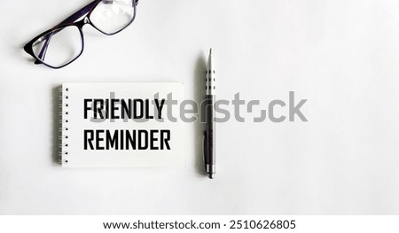 Friendly reminder text on note pad with a pen - A reminder to perform certain task