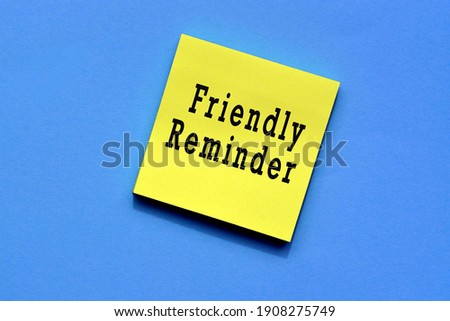 Friendly reminder text on yellow sticky note with blue background