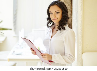 Friendly Restaurant Hostess Posing At Camera