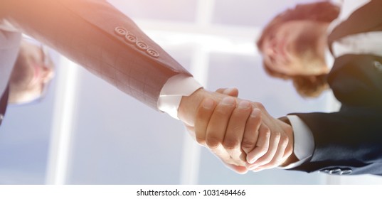 Friendly smiling businessmen handshaking. Business concept photo - Shutterstock ID 1031484466