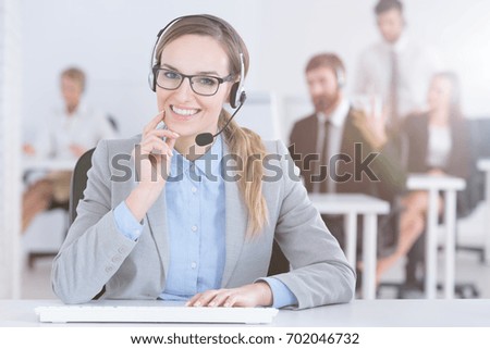 Friendly smiling call center worker wearing a headset