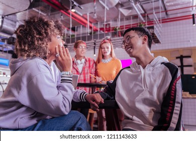 Friendly Talk. Shy Asian Boy Leaning Arm On Table While Looking At His Girlfriend