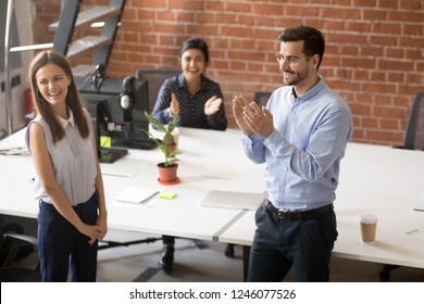 Friendly team leader, boss introducing to colleagues hired new member of team, newcomer, applauding to female employee, congratulating office worker with promotion, business success, reward - Shutterstock ID 1246077526