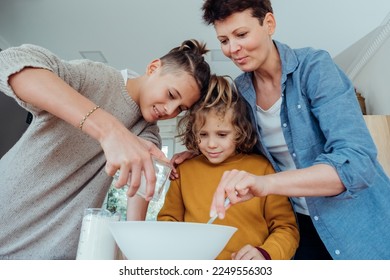 Friendly togetherness of parents and children.Mother cooking with sons.  - Powered by Shutterstock