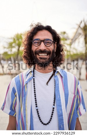 Friendly vertical portrait of handsome Italian man looking at camera smiling. Caucasian male on holidays.