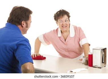 Friendly Waitress Winks At A Customer As She Wipes Down The Lunch Counter. White Background.