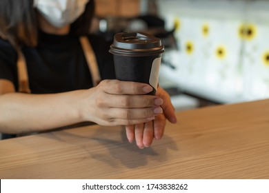 Friendly Woman Barista Wearing Protection Face Mask Waiting For Serving Ice Black Coffee To Customer In Cafe Coffee Shop, Cafe Restaurant, Service Mind, Small Business Owner, Food And Drink Concept