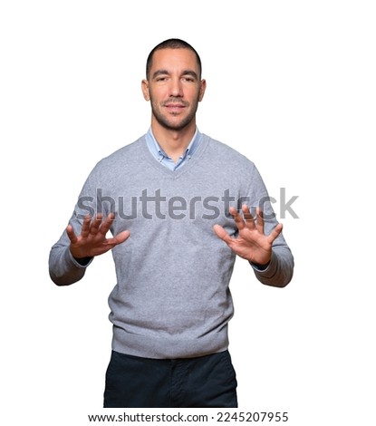 Friendly young man doing a gesture of keep calm