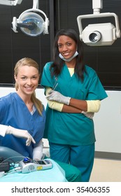 Friendly Young Multi Ethnic Personnel Group Graduated Dentist And Assistant Caucasian Blond And African-American Are Smiling At Dental Office