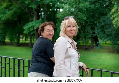 Friends Of 50-60 Years Old Spend A Day Off In The Park. Retirement Travel Time