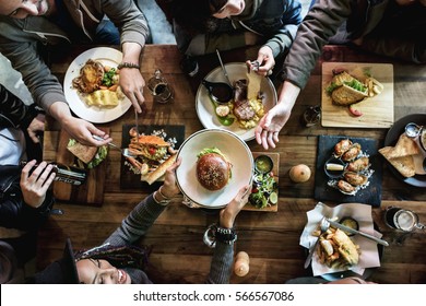 Friends all together at restaurant having meal - Shutterstock ID 566567086