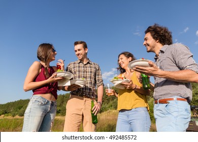 Friends at barbecue party in nature drinking beer and eating hamburger sandwiches - Shutterstock ID 492485572