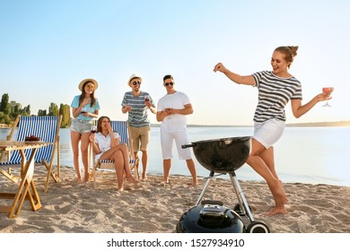 Friends at barbecue party near river - Powered by Shutterstock