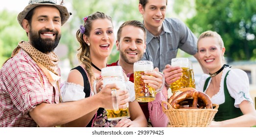 Friends In Bavarian Beer Garden Drinking In Summer