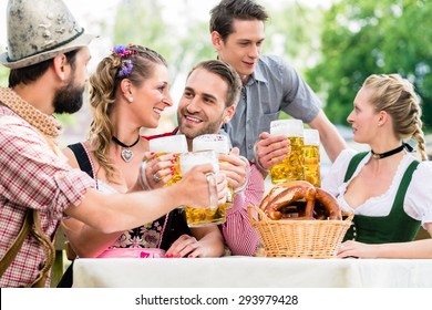 Friends In Bavarian Beer Garden Drinking In Summer