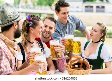 Friends In Bavarian Beer Garden Drinking In Summer