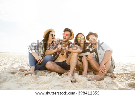 Similar – Young friends holding woman on top of surfboard